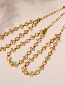 Detailed macro view of 18k gold plated bracelets with zircon plum blossoms and round stones