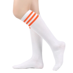 Close-up of white knee-high socks with orange triple stripes and ribbed cotton texture