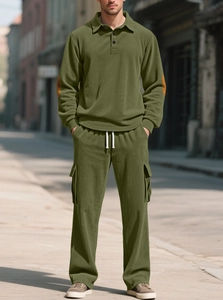 Olive green corduroy tracksuit detail with stylish brown elbow patches and ribbed texture