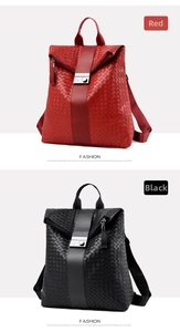 Close-up of red and black woven leather backpacks with silver metallic buckles