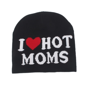 Close-up of black knitted beanie featuring I Heart Hot Moms jacquard lettering and red heart