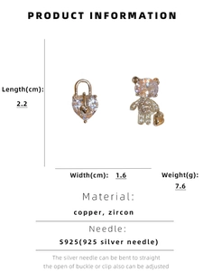 Detail view of asymmetric bear and heart lock earrings with zircon inlay and S925 silver pins
