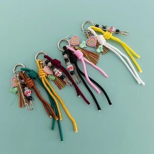 Detail view of colorful macaron woven keychains with heart charms and tassels