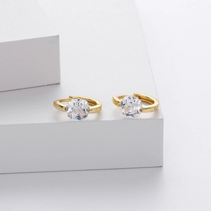 Macro detail of gold S925 sterling silver earrings with square transparent zircon stones