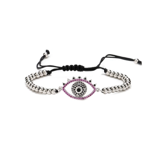 Adjustable copper bracelet with evil eye motif featuring pink and black cubic zirconia