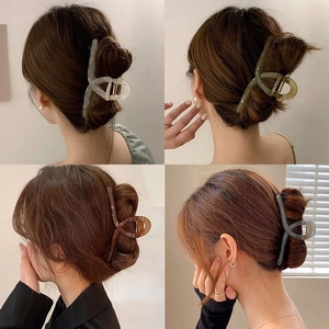 Minimalist large matte hair claws in four colors shown on a model from different angles