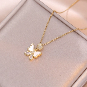 Elegant gold butterfly pendant necklace with zircon accents on a soft jewelry box