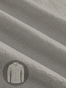 Detailed macro view showing the natural linen texture and chest pocket of the gray shirt