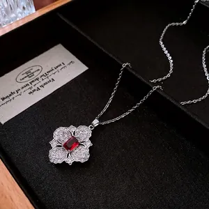 Vintage hollow flower necklace with red zircon gemstone in a black jewelry box