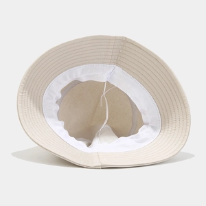 Beige bucket hat featuring inner sweatband, adjustable drawstring and durable stitching