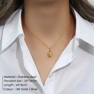 Minimalist 14K gold stainless steel necklace with twisted oval pendant worn by a model