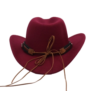 Detail of wine red western cowboy felt hat featuring a dark brown decorative band and tie