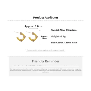 Detail showing gold C-shaped bamboo earrings with rhinestones and 1.8cm diameter specifications
