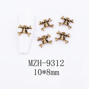 Detail of 10x8mm retro skull nail charms in antique gold finish for Halloween manicure