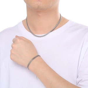 Men's silver wheat chain necklace and bracelet set shown on model in white t-shirt