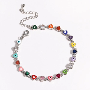 Detail view of silver bracelet with colorful heart evil eye charms and zircons