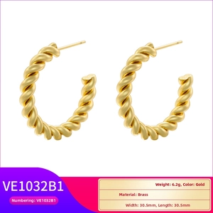 Detailed view of gold-plated twisted rope hoop earrings made of high-quality brass