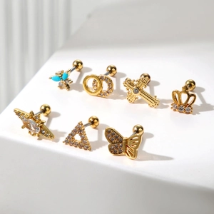 7-piece set of golden stainless steel ear studs featuring butterfly, crown, and star designs