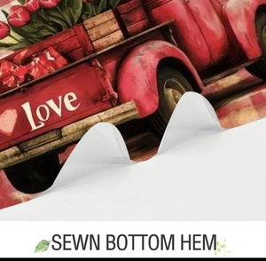 Detail of sewn bottom hem on shower curtain featuring vintage red love truck pattern