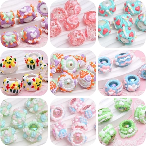 Macro view of colorful acrylic beads with hearts and dots for DIY jewelry making