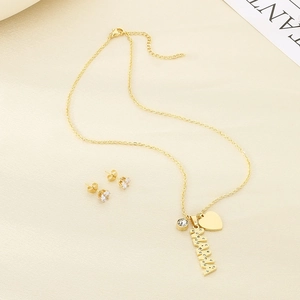 Golden MAMA necklace and heart stud earring set with sparkling crystals on beige fabric