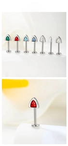 Macro shot of F136 titanium triangle cartilage studs with seven colorful crystal inlays