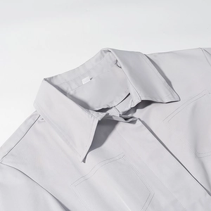 Close-up of lapel collar and double breast pockets on light gray business suit jacket