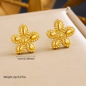Elegant 1cm gold plated flower stud earrings weighing 2g on a soft textured surface
