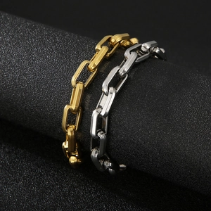 Detail of silver and gold titanium steel link chains wrapped on a black cylinder
