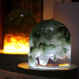 Close-up of green natural stone resin night light on a circular wooden LED base