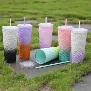 Detailed view of double-layer studded plastic tumblers in vibrant gradient colors