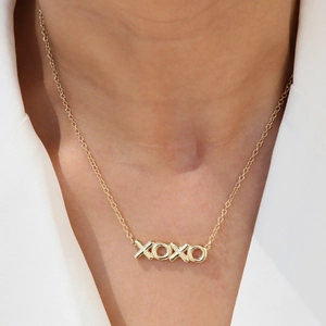 Chic 18k gold plated brass XOXO pendant necklace on a model for a trendy ins look