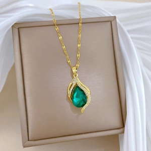 Elegant gold titanium necklace with pear-shaped green gemstone and pavé diamonds
