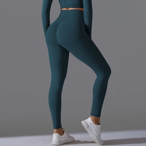 Detail showing high-waisted dark green leggings and crop top for yoga fitness
