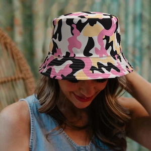 Stylish camo bucket hat in pink and yellow for outdoor sun protection on a model