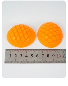Detailed view of artificial mango cubes with realistic texture and 5cm ruler for scale