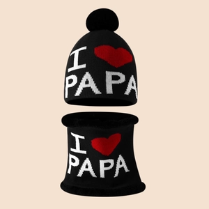 Detail of winter knitted beanie and neck warmer set with I Love PAPA pattern and pompom