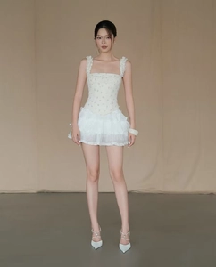 Detail van een witte gebloemde top en gelaagde rok in lichte chiffon kwaliteit