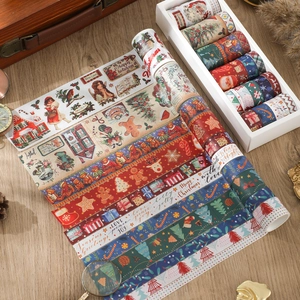 Flat lay of vintage Christmas washi tape set with Santa and reindeer motifs on wood