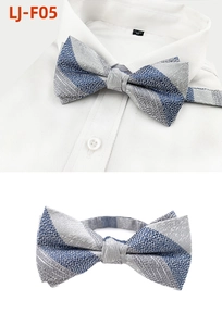 Macro detail of navy and grey striped men's pre-tied bowtie with fine woven texture