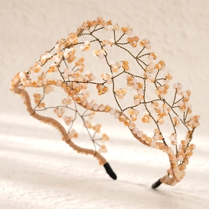 Detailed view of handmade woven bridal headband with peach faceted crystal beads