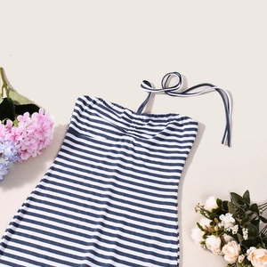 Detail of blue and white striped halter jumpsuit with cut-out and tie-neck design