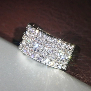 Macro shot of wide band ring featuring multiple rows of pavé set sparkling zircons