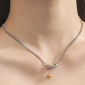 Minimalist titanium steel necklace featuring a silver chain and a round golden pendant hook