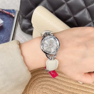 Close-up of elegant women's watch with crystal petal dial and white leather strap