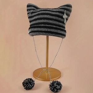 Striped knit cat ear beanie with silver crosses and pompom drawstrings in black and grey
