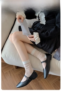 Detailed view of women's ribbed mesh socks with elegant agaric lace cuffs in soft beige