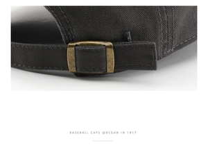 Detail of adjustable metal buckle and stitching on charcoal cotton baseball cap