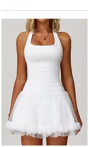 Front view of model wearing a white ballet style backless sports dress with mesh tutu skirt