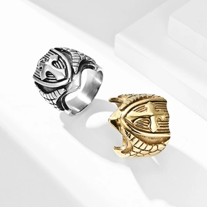 Close-up of vintage steel rings with embossed cross shield and wing patterns in gold and silver